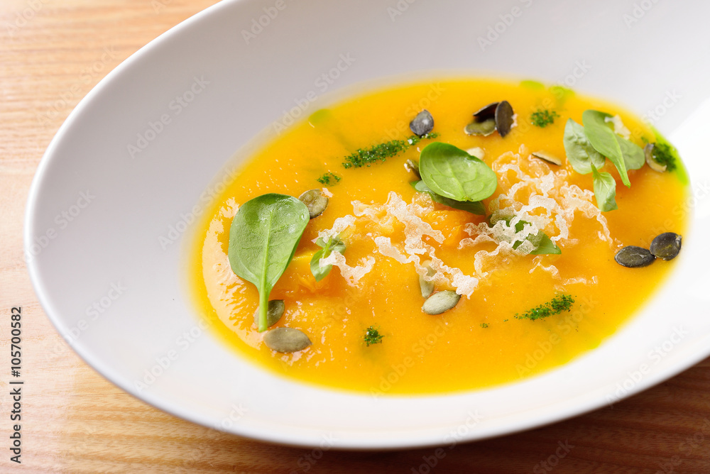 pumpkin cream soup with cheese, greens and pumpkin seeds, isolat pumpkin cream soup with cheese, greens and pumpkin seeds, isolat