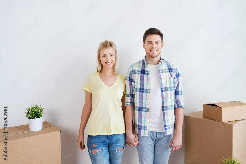 smiling couple with big boxes moving to new home smiling couple with big boxes moving to new home