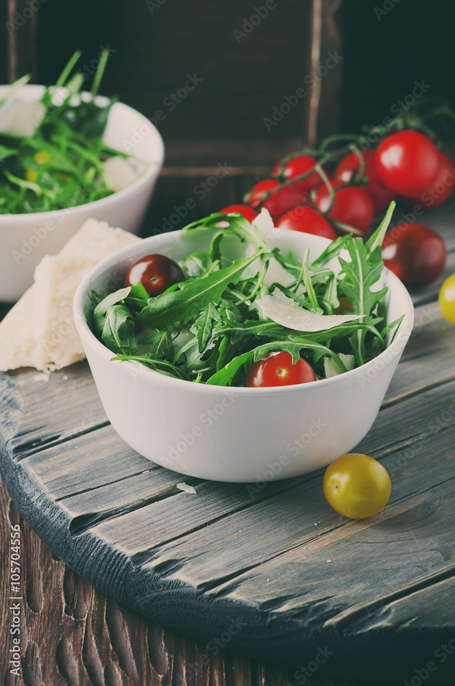 Healthy salad with rocket, tomato and parmesan cheese Healthy salad with rocket, tomato and parmesan cheese