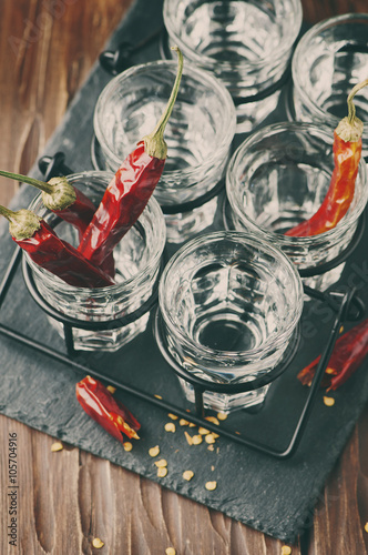 Glasses of vodka with hot chili peppers