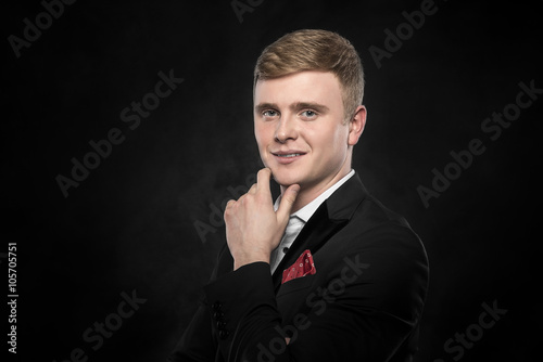 Young handsome man in black suit.