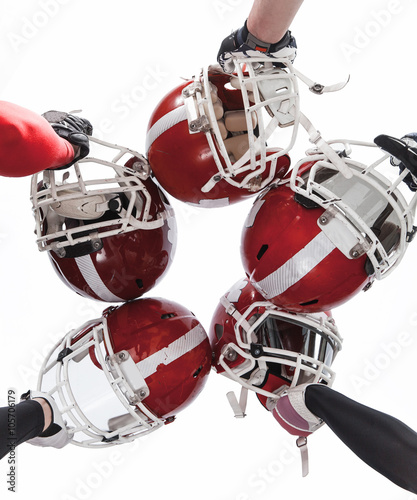 The hands of american football players with helmets on white background