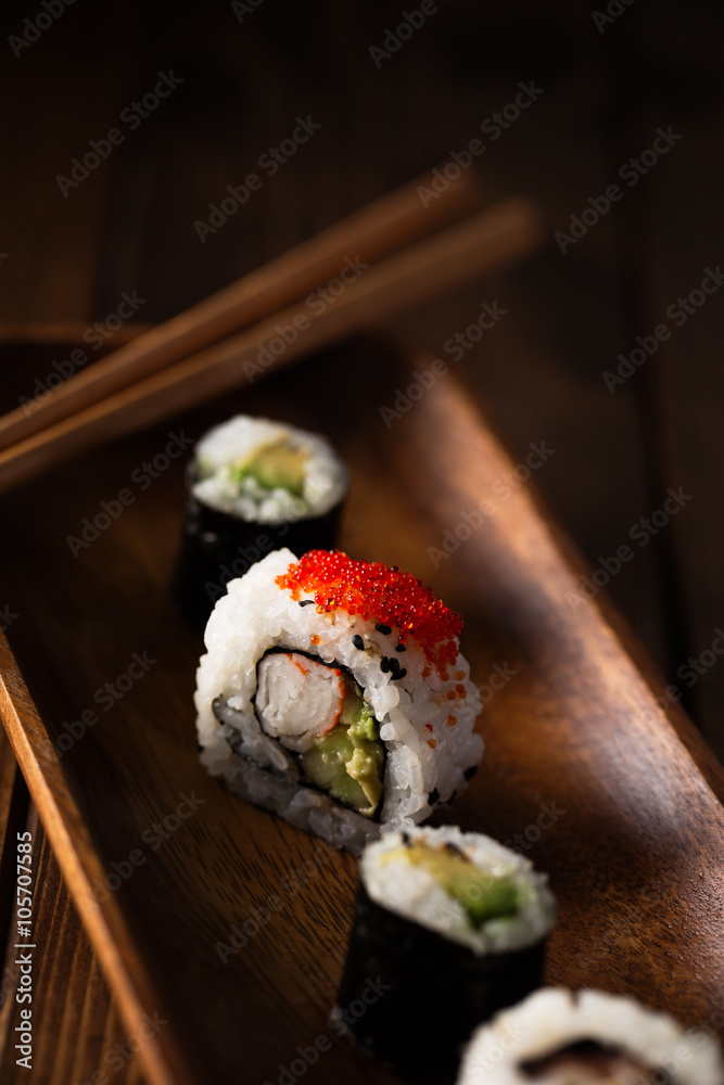 Healthy maki sushi on a wooden plate