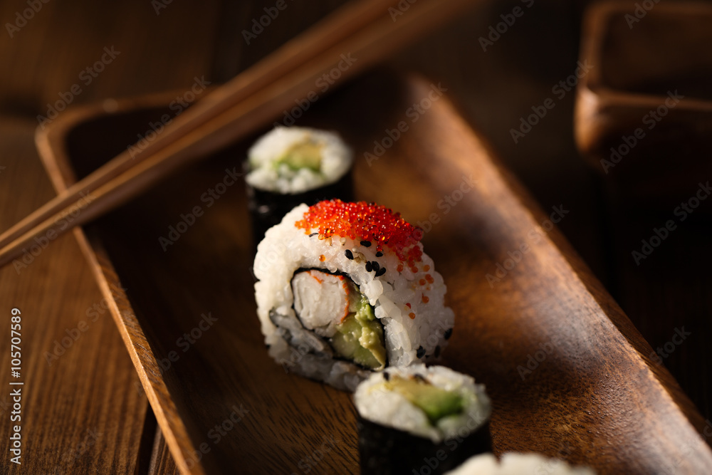 Healthy maki sushi on a wooden plate