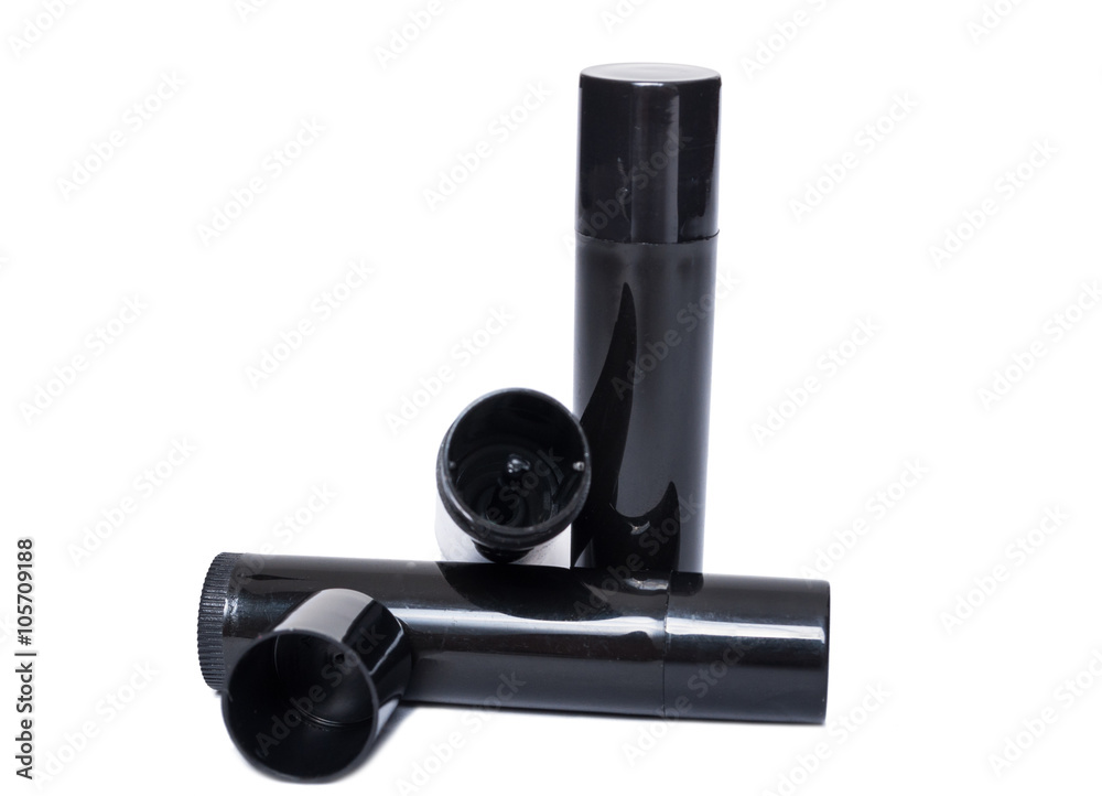 Lips moisturizer black plastic containers isolated on white