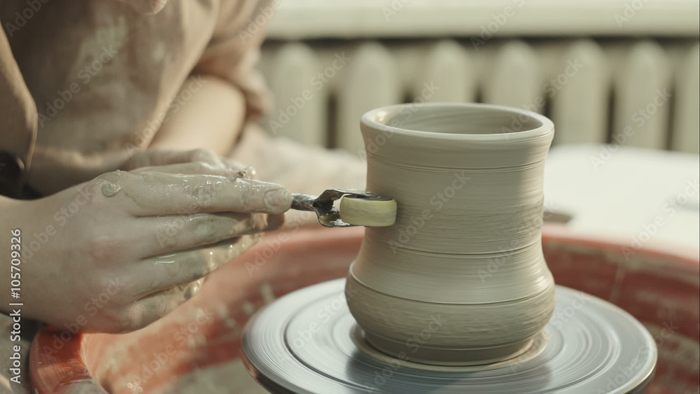 The young potter puts pattern on clay vase. RAW video record. The young potter puts pattern on clay vase. RAW video record.