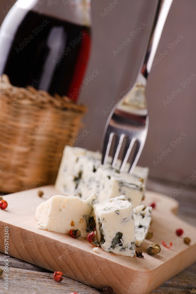 Few pieces of blue cheese on wooden board