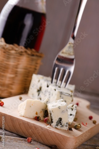 Few pieces of blue cheese on wooden board