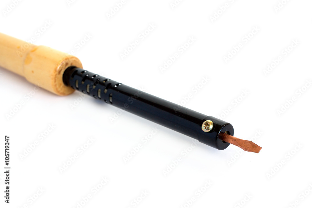 Electric soldering iron with brown wooden handle and copper stig isolated on white background side view closeup Electric soldering iron with brown wooden handle and copper stig isolated on white background side view closeup