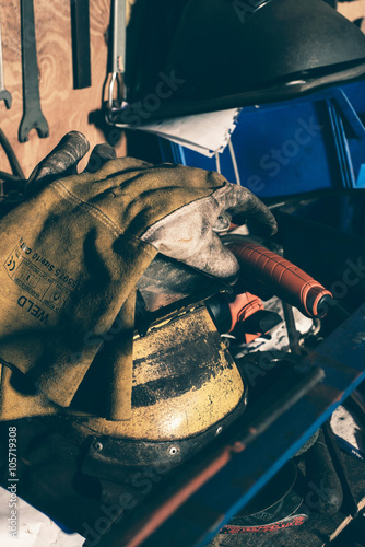 Safety welding gloves lying on mask