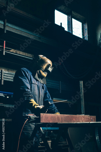 Welder with mask in workplace