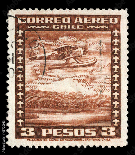 Stamp printed in Chile shows Stinson Faucett F.19 seaplane in flight, circa 1934. photo