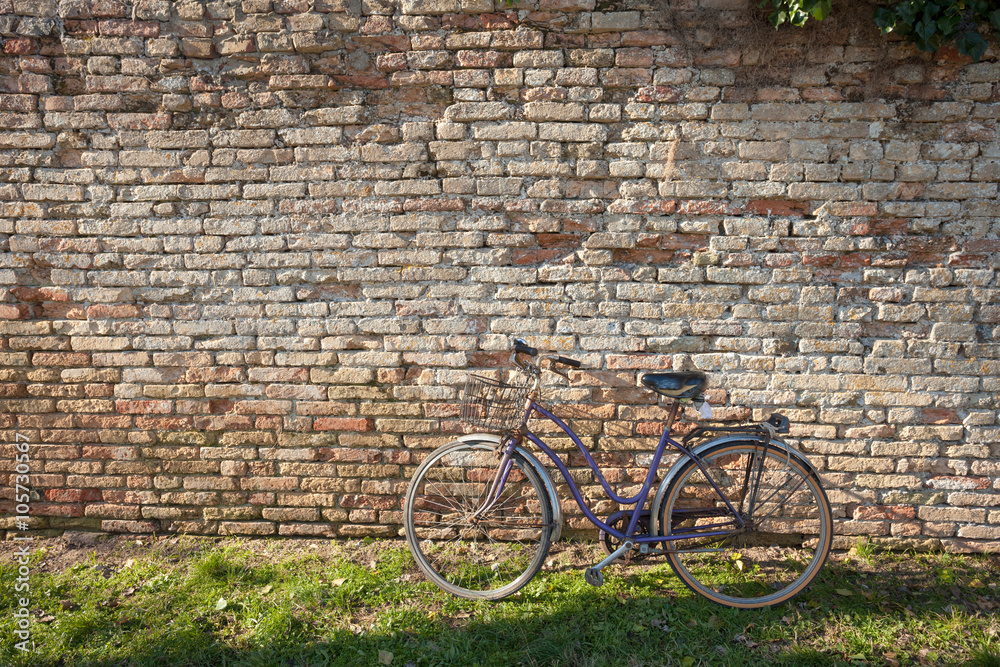 old bicycle parked long an external wall in Burano island, Venic old bicycle parked long an external wall in Burano island, Venic
