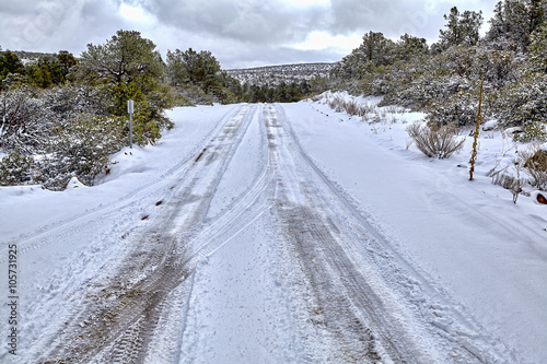 Snow covered road winter tire track dangers