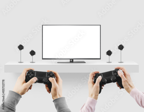 Man hold gamepad in hands in front of blank tv screen mock up player. photo