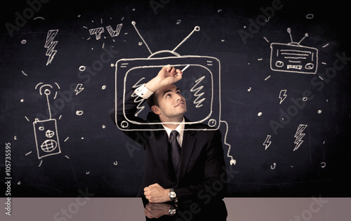 Happy businessman drawing tv and radio