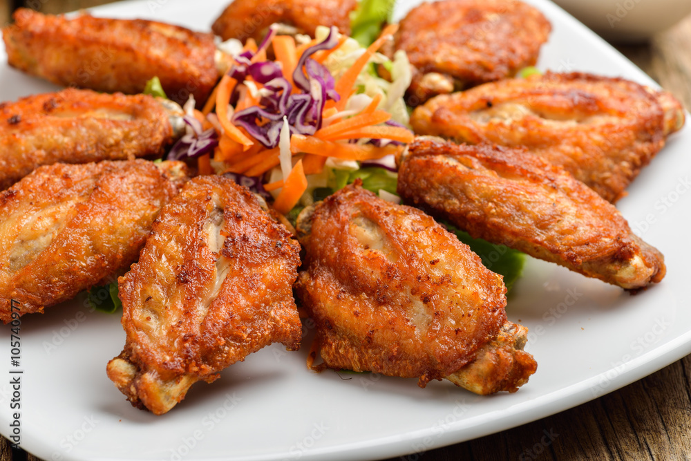 Buffalo chicken wings on white plate wooden background Buffalo chicken wings on white plate wooden background