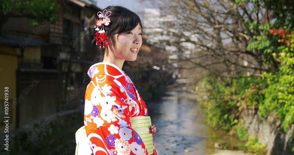 Beautiful Japanese girl in Kimono turns to the camera medium shot Beautiful Japanese girl in Kimono turns to the camera medium shot