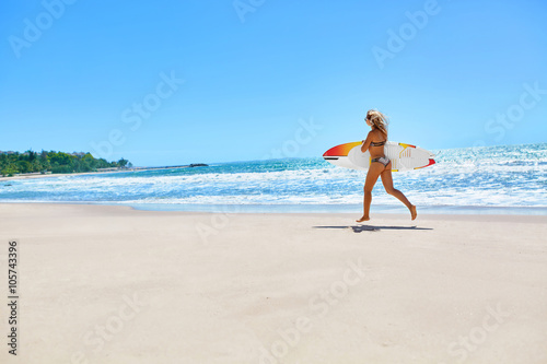 Summertime. Surfing. Summer Leisure Sport Activity. Beautiful Sporty Young Woman With Sexy Body In Bikini With Surf Board Running On Beach. Extreme Water Sports. Healthy Lifestyle. Holiday Vacations.