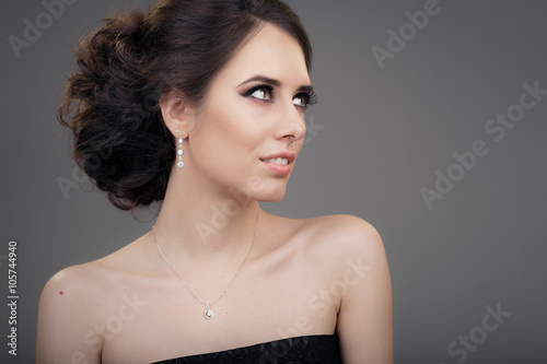 Beautiful Woman in Black Evening Dress Wearing Jewelry 