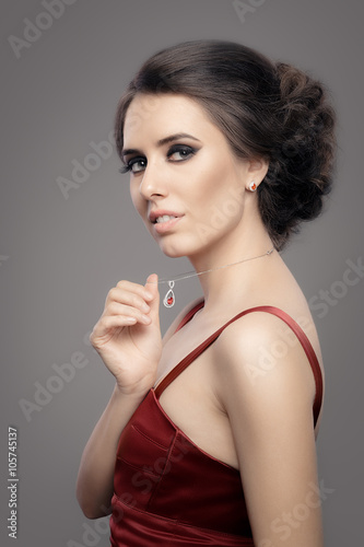 Beautiful Woman in Red Elegant Dress Wearing Ruby Jewelry - Portrait of a gorgeous girl with diamond jewellery and evening dress