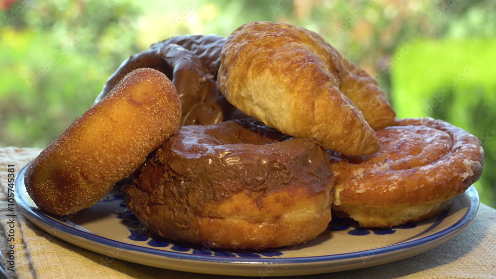 Assorted Donuts and Croissant Rotating on a platter. Assorted Donuts and Croissant Rotating on a platter.
