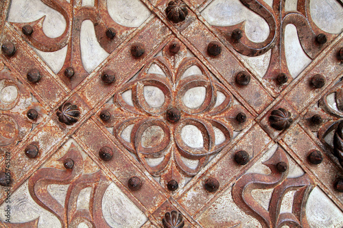 Rusty details and ornaments of wrought iron medieval door