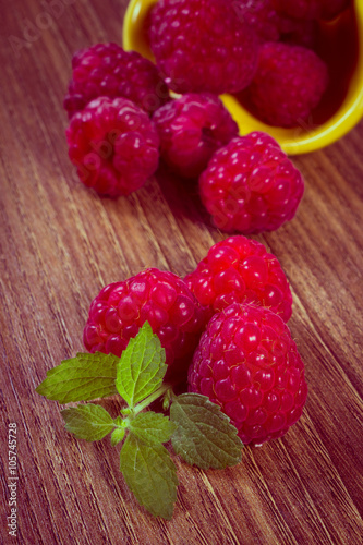 Vintage photo, Fresh raspberries and lemon balm on wooden surface, healthy food