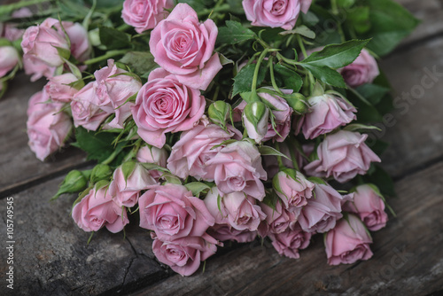 Bouquet of pink roses on vintage wooden floor © Laszlo