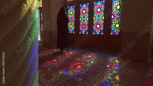 Young Muslim woman praying in Nasir Al-Mulk Mosque (Pink Mosque), Iran, Shiraz photo