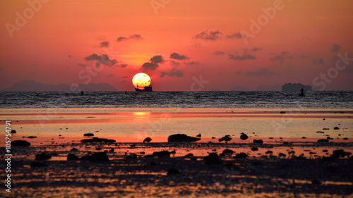 Sunrise over the sea at  phuket thailand with silhouette of fish