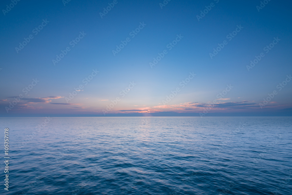 Beautiful sunset with blue sea and sky peaceful background long