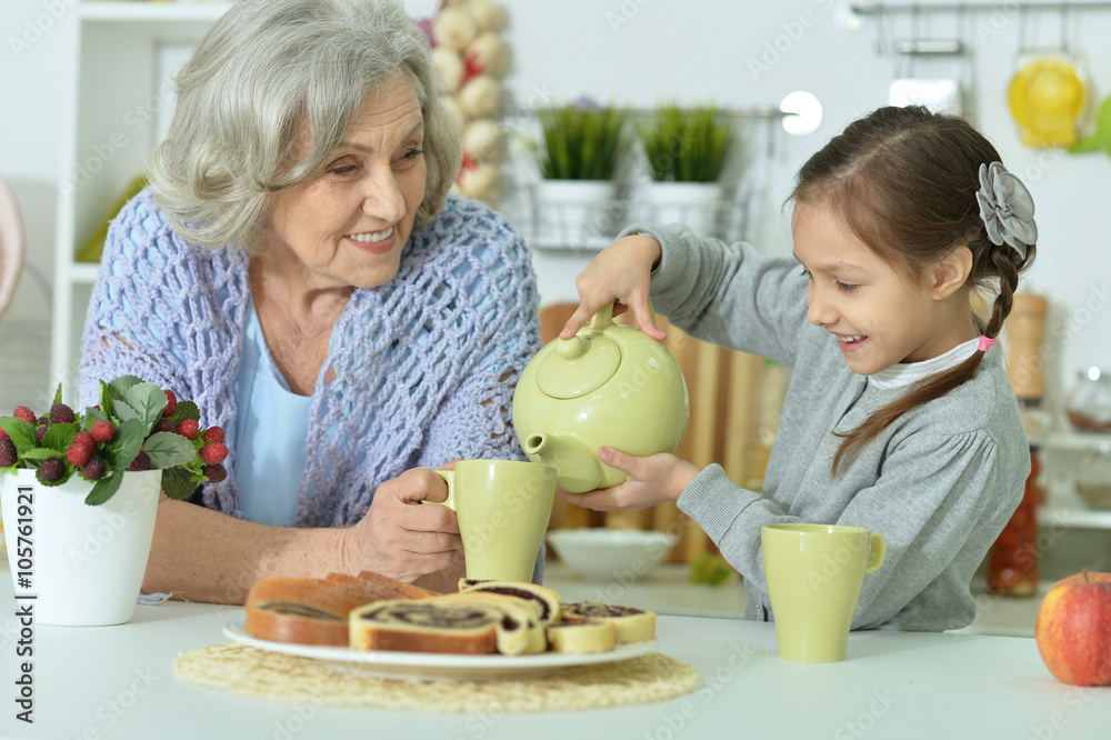 Senior woman with granddaughter with tea