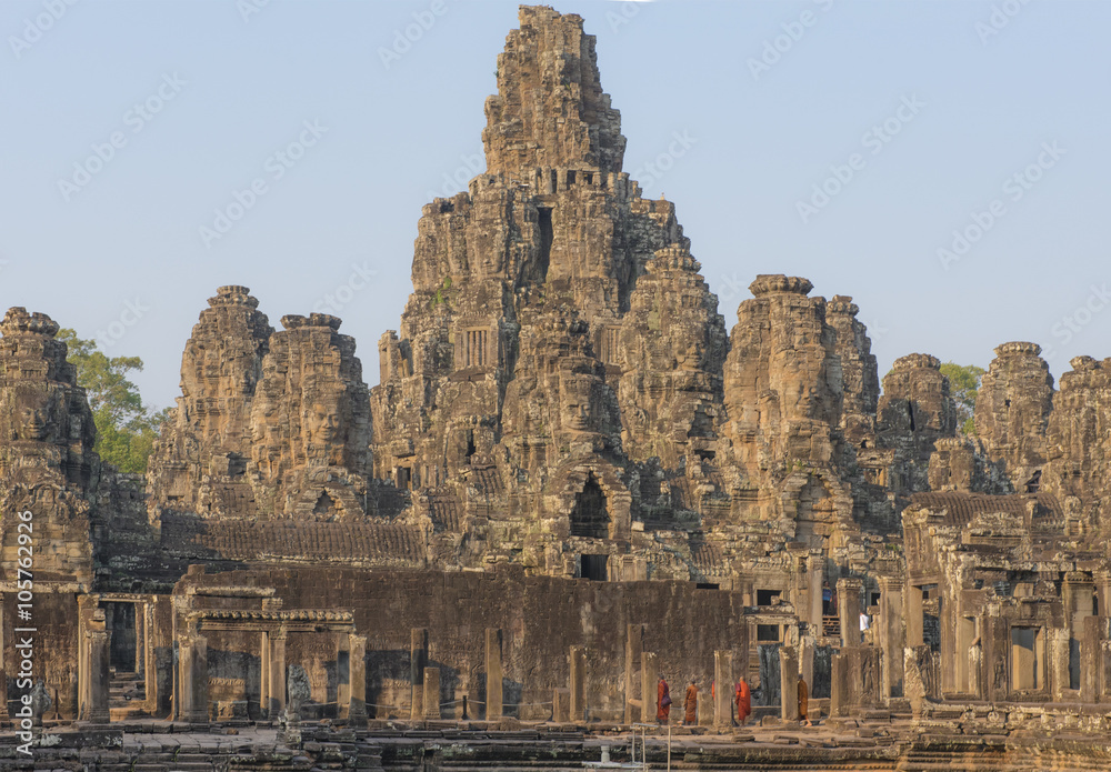 Bayon temple in Angkor Thom with Buddhist monks, Cambodia