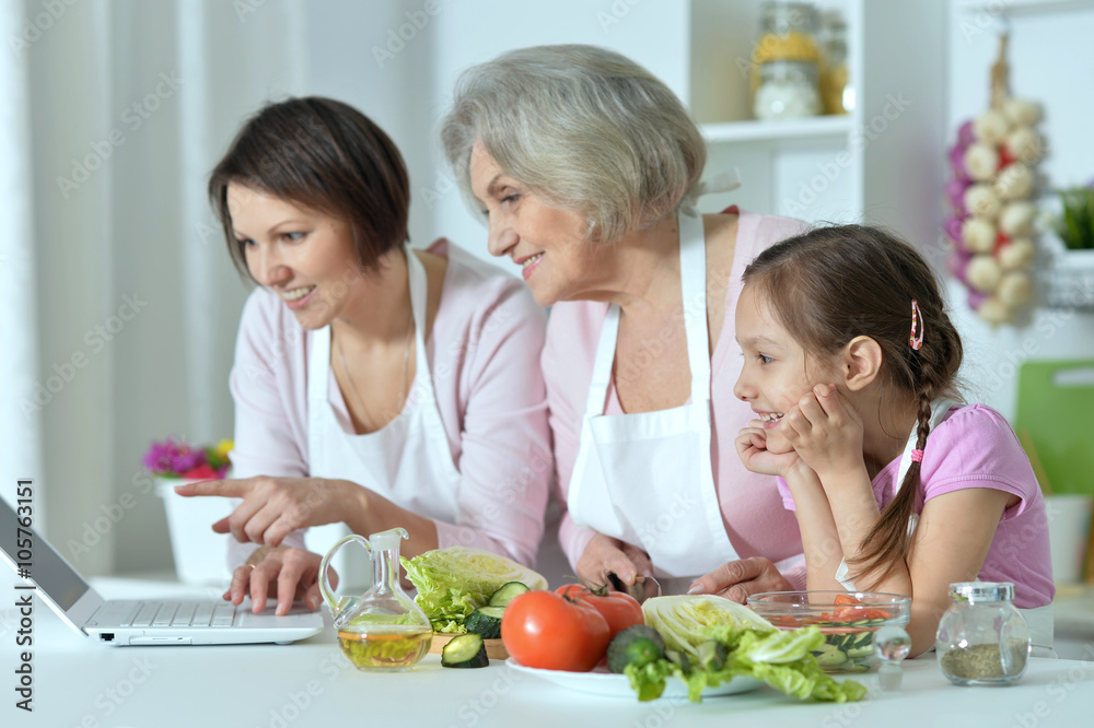 women with little girl cooking