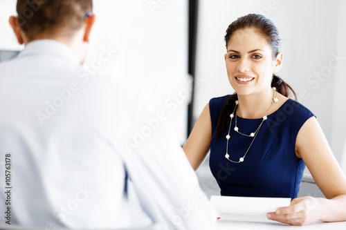 Attractive office worker sitting at desk