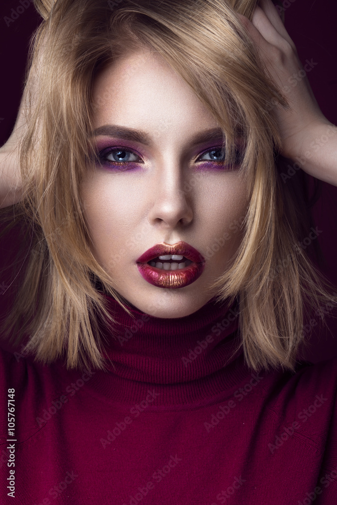 Beautiful blonde woman in a red sweater with bright makeup and dark lips. Beauty face. Beautiful blonde woman in a red sweater with bright makeup and dark lips. Beauty face.