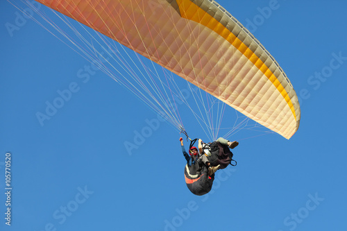 A man and woman paragliding