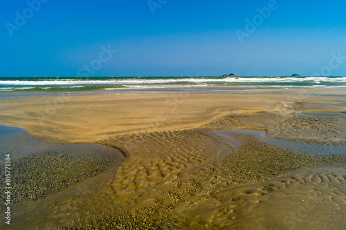 Low tide sand and water .