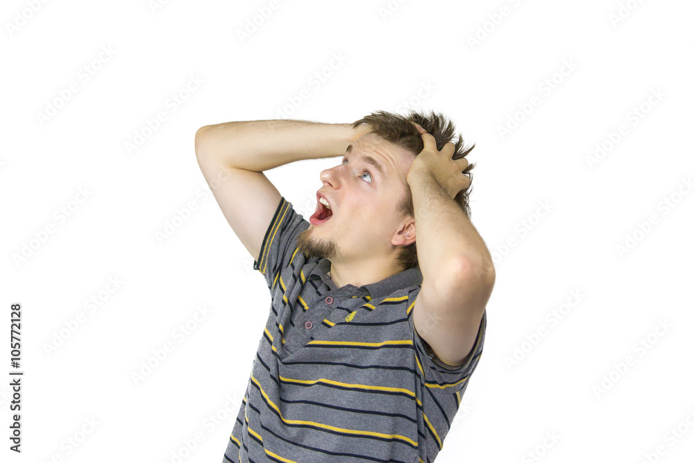 Shocked young man looking up, thinking Shocked young man looking up, thinking