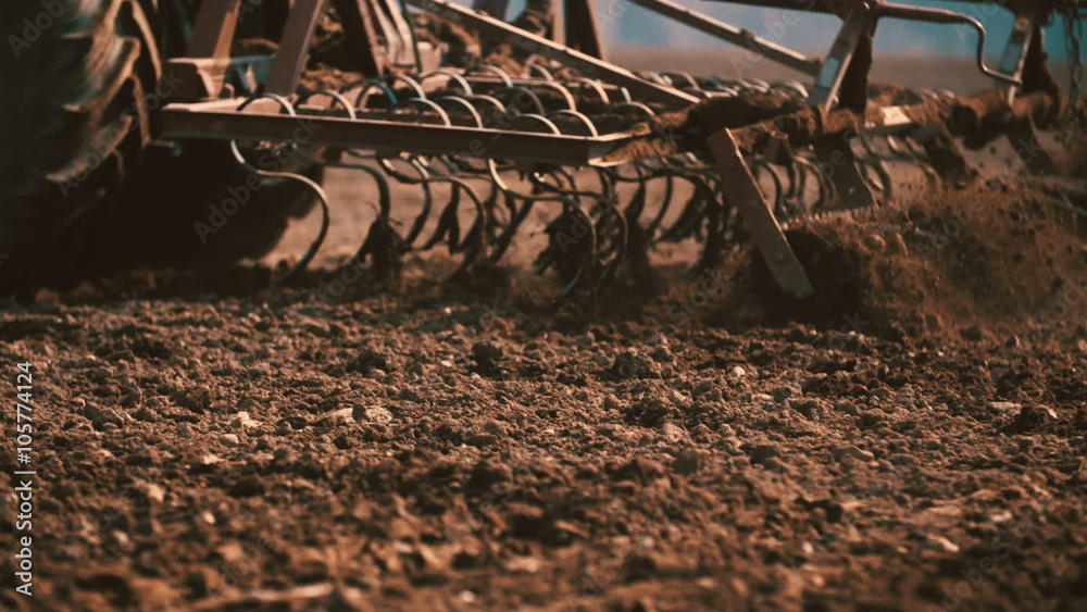Agricultural tractor sowing and cultivating field
