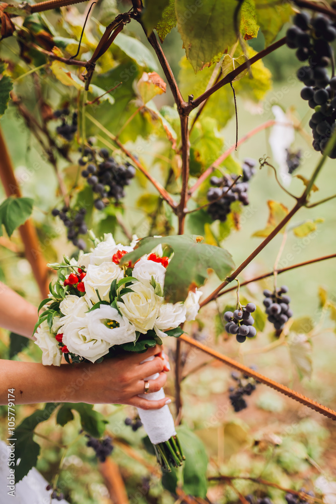 Fototapeta premium beautiful wedding bouquet with peony, roses, orchids, and green leaves.