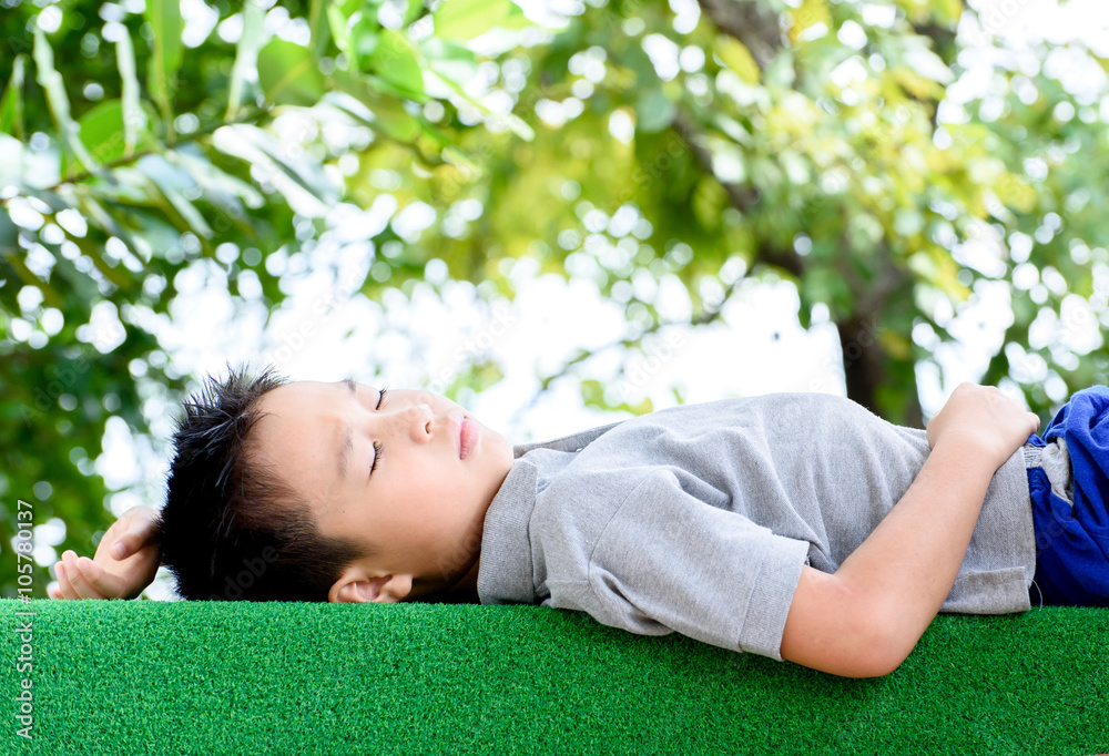 Boy lay on the green lawn Boy lay on the green lawn