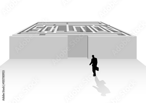 Silhouette of businessman walking into maze