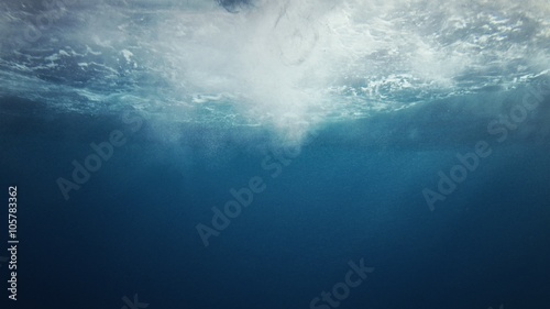 Beautiful underwater sea scene view with natural light rays, slow motion, the water glittering and have moving surface, caustics, bubbles, and foam, perfect for background and digital composition photo