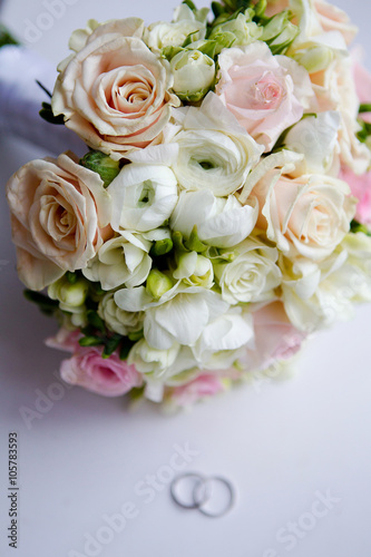 wedding bouquet on the table with rings