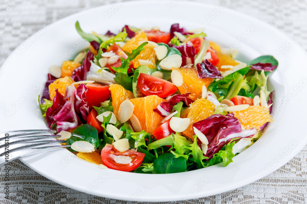 Fresh Orange, vegetables salad on white plate