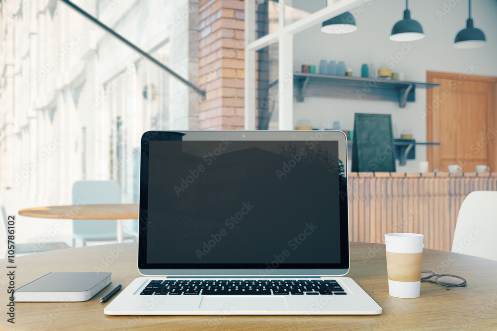 Blank laptop, coffee and notebook