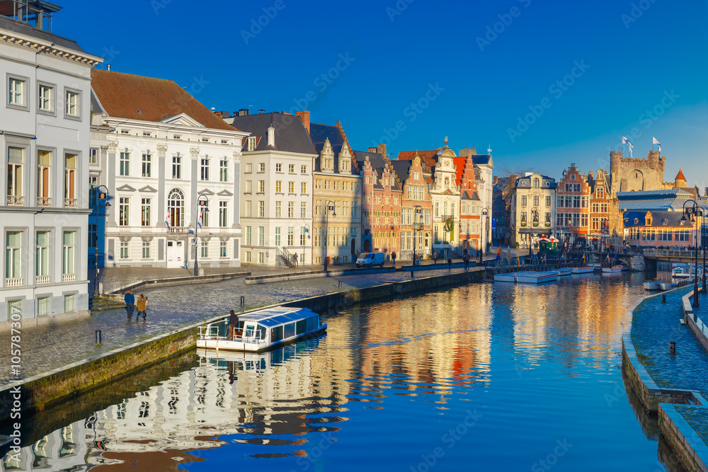 Picturesque medieval buildings on quay Korenlei and  quay Graslei,  Leie river in the morning, blue hour, Ghent, Belgium