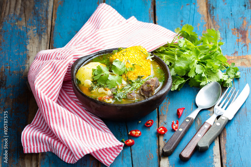 Latin american food. Cazuela - traditional chilean soup served in clay plate from pomaire photo